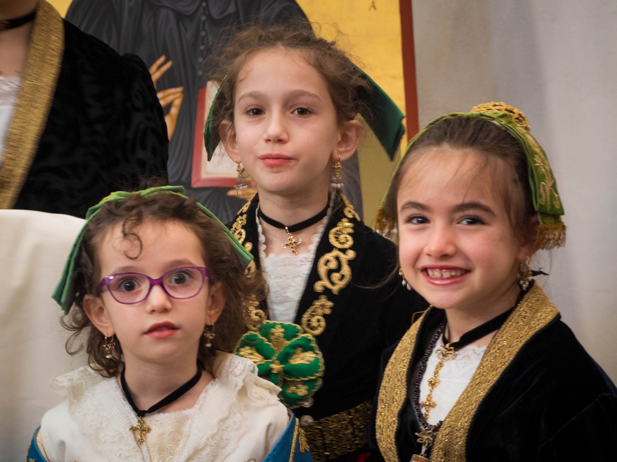 A trio of girls dressed in traditional costumes at Arbëreshë: Easter in Piana Degli Albanesi