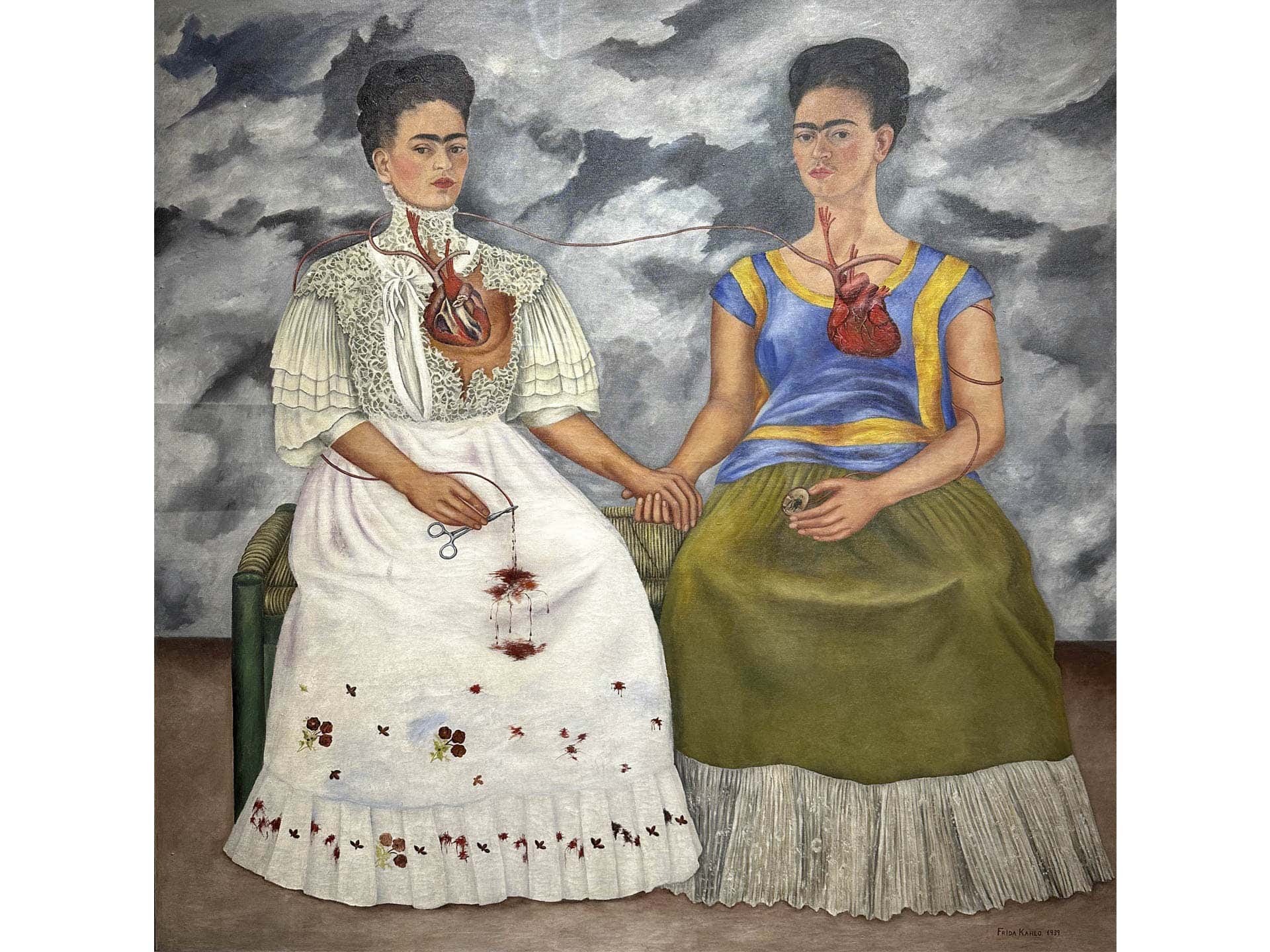 "The Two Fridas", 1939, 1.74 m X 1.73 m, oil on canvas, Museo de Arte Moderno in Mexico City, A divided woman: heroic flamboyance conflicted with inner darkness, femininity contrasted with androgyny, the victim and the martyr
